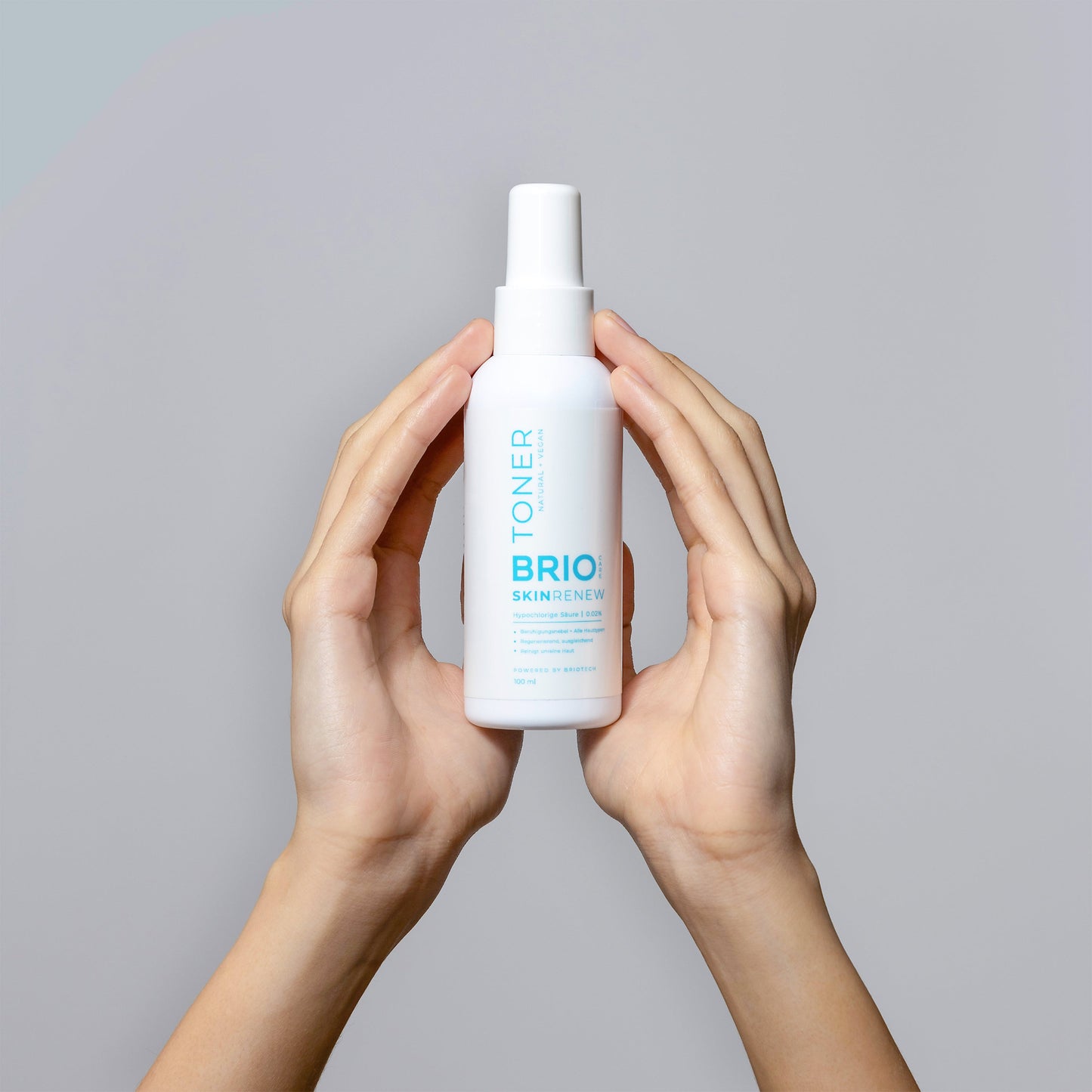 Hands holding a bottle of Skin Renew Toner which suitable for all skin types, even sensitive skin.